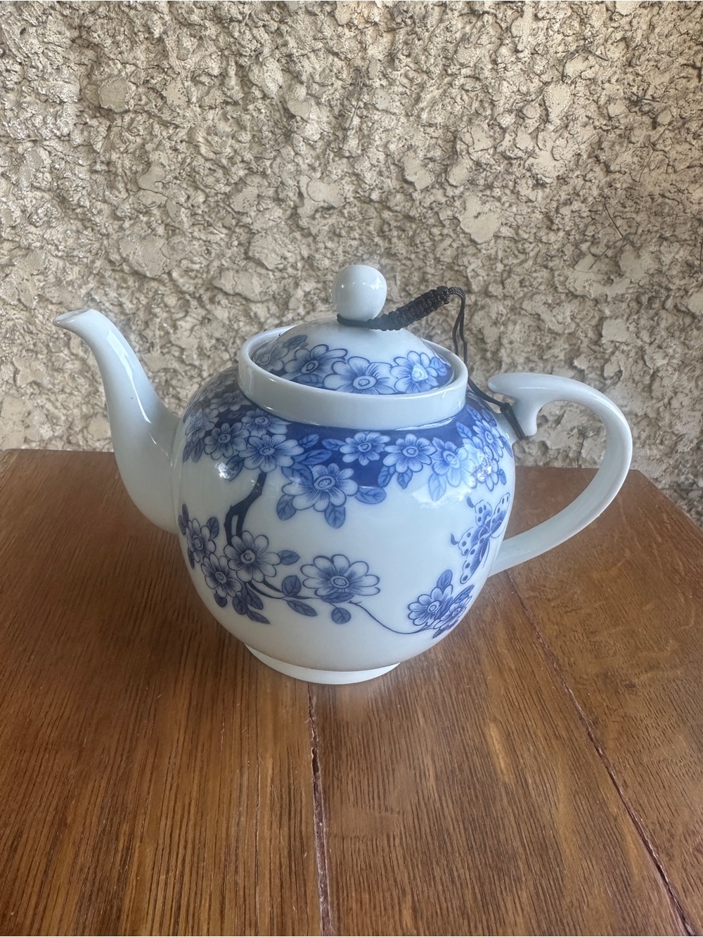 Blue and white floral teapot with butterfly design